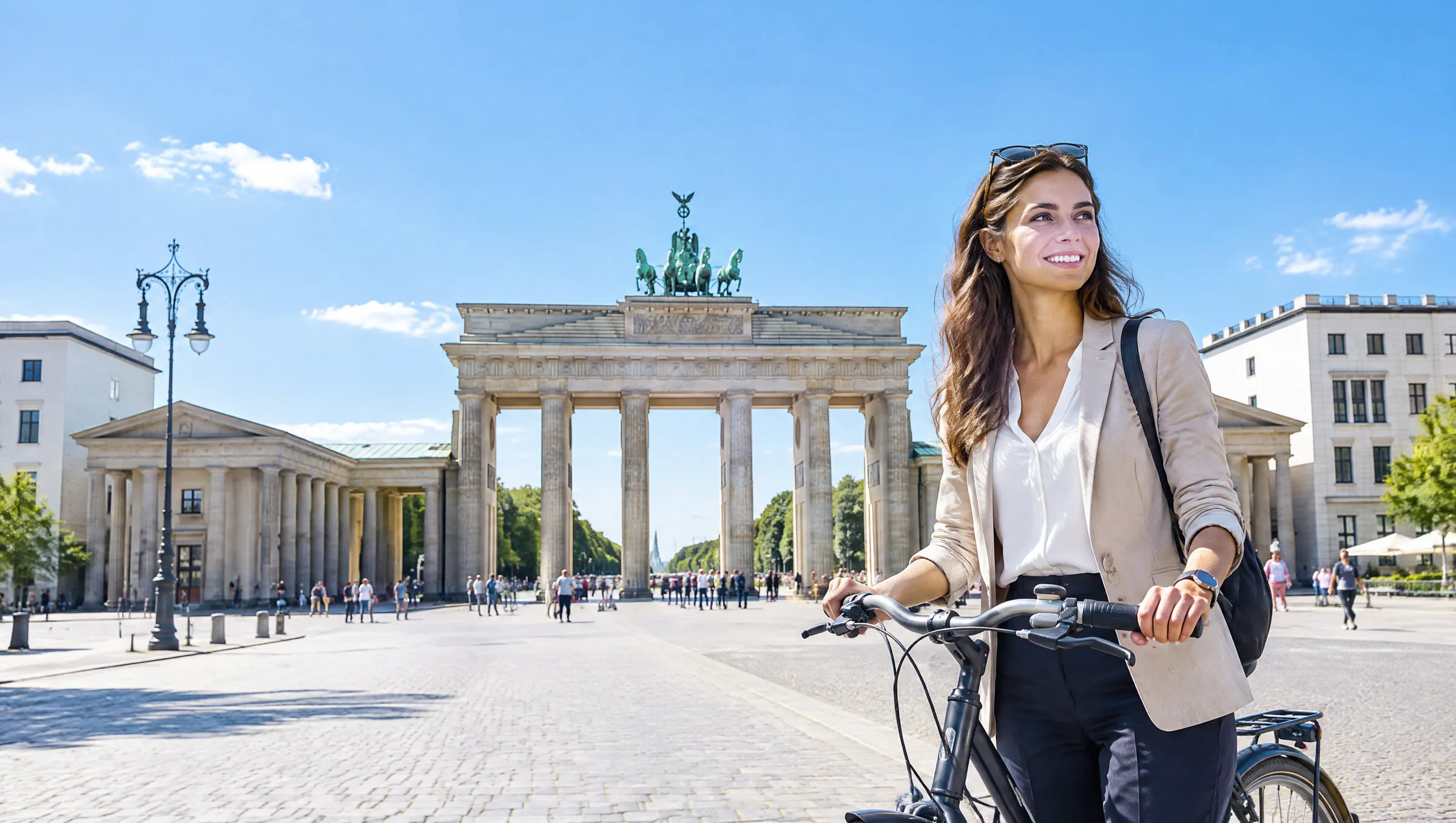 A professional with a bicycle in front of the Brandenburg Gate in Berlin